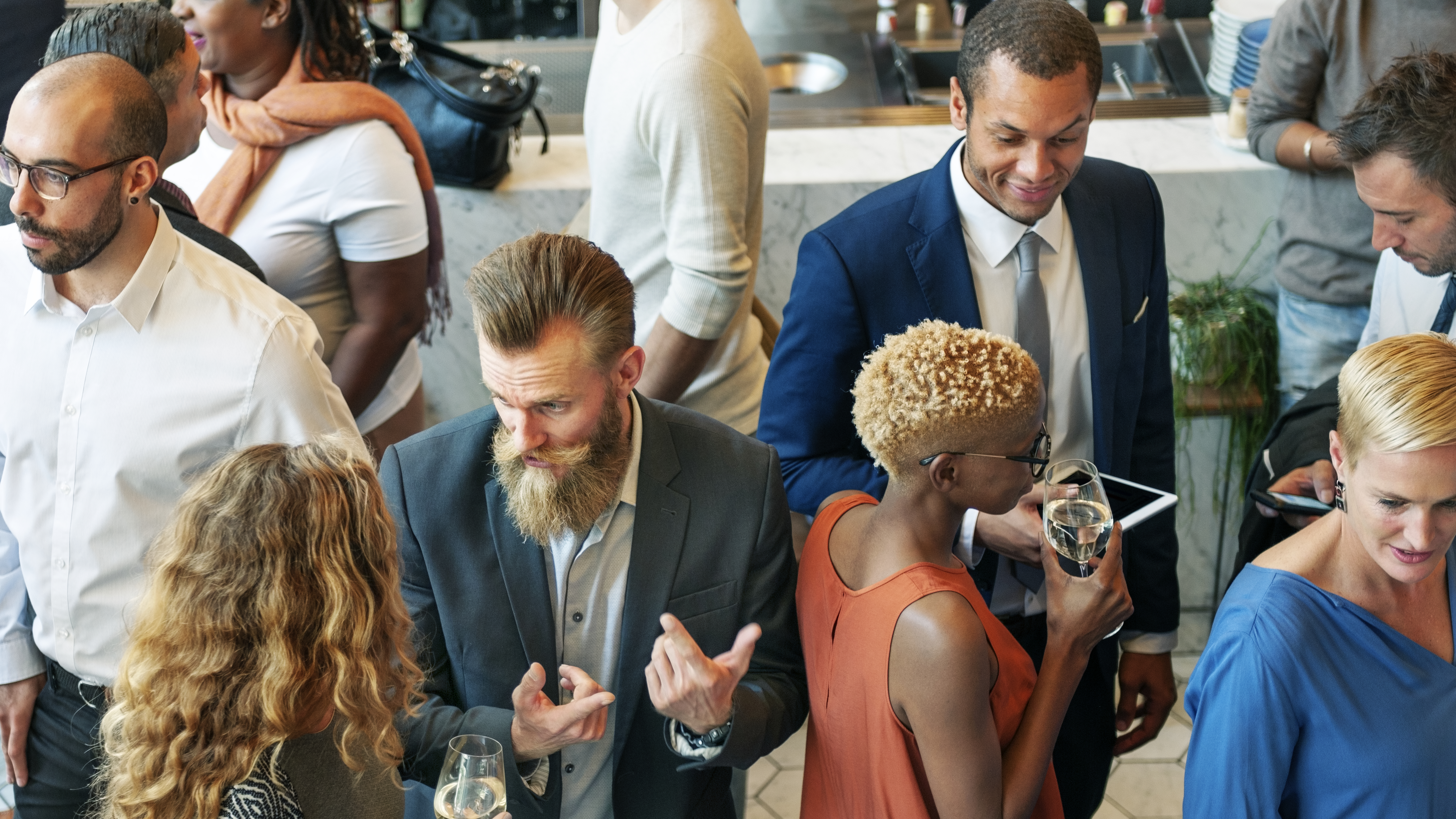 Professionals networking at a B2B corporate event, using eco-friendly promotional gifts to enhance brand engagement and emotional connection.